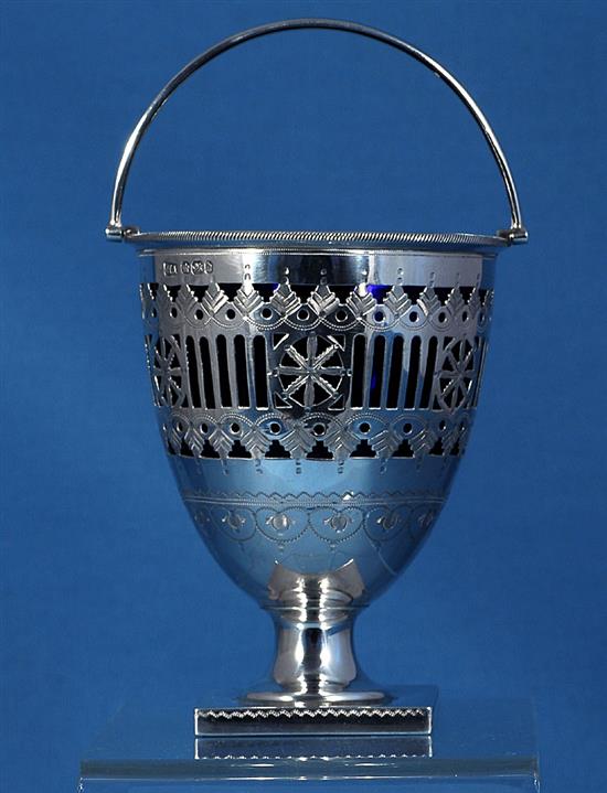 A late Victorian silver swing handled sugar basket with a blue glass liner, by Atkin Brothers, height 165mm, weight 4.9oz/154grms.